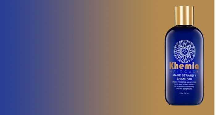 Blue and gold Khemia Aircare shampoo bottle with label against a gradient background.